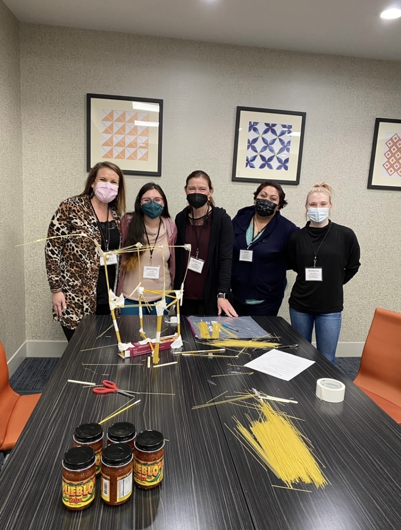 Natasha Couoh, VISTA Member in the blue shirt, at the Leadership Pueblo 3-Day Leadership Retreat in January - Teambuilding event to build the largest tower of pasta that they won!