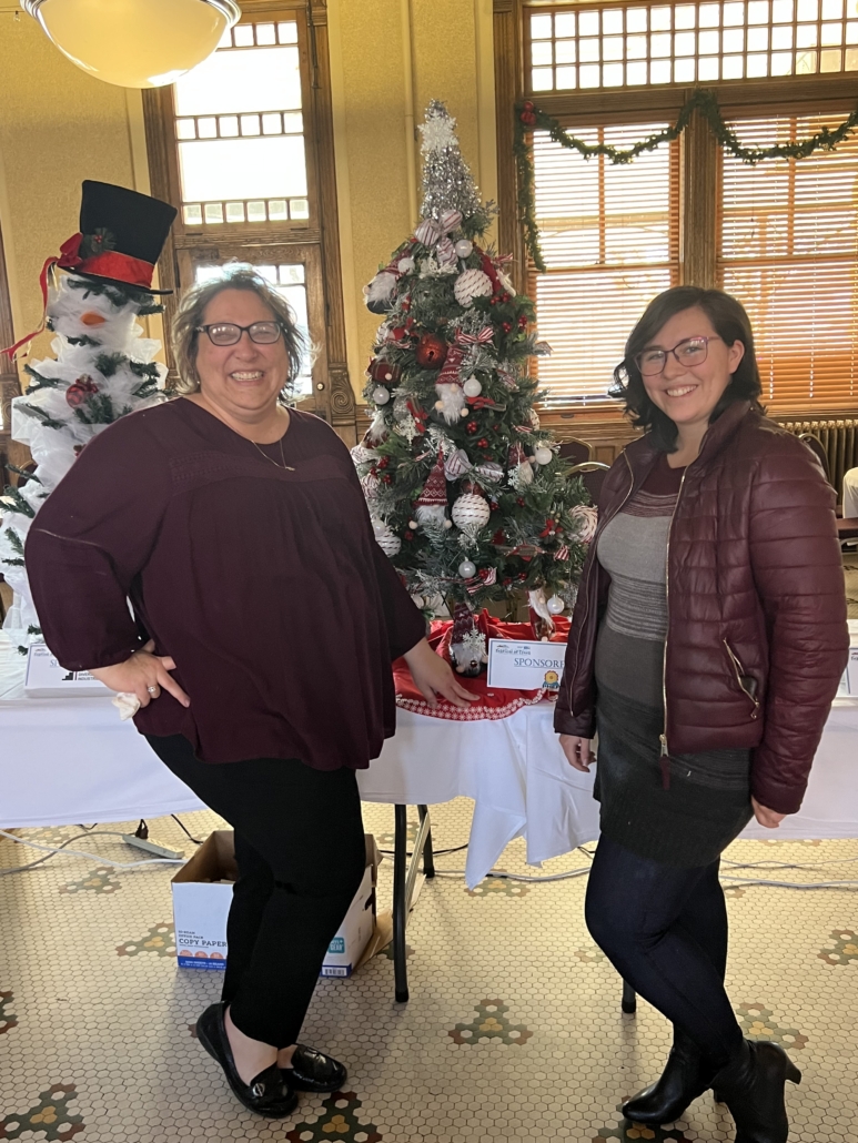 Natasha Couoh, VISTA Member on the right, with Janelle Quick, Supervisor at Pueblo Hispanic Education Foundation, at the Festival of Trees Fundraiser where they decorated and auctioned this tree for $125